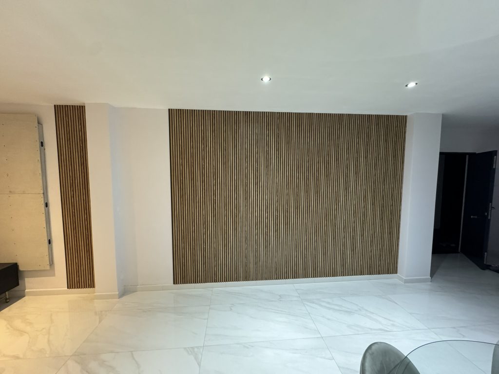 Pared decorativa con listones de madera en salón moderno con suelos de mármol blanco