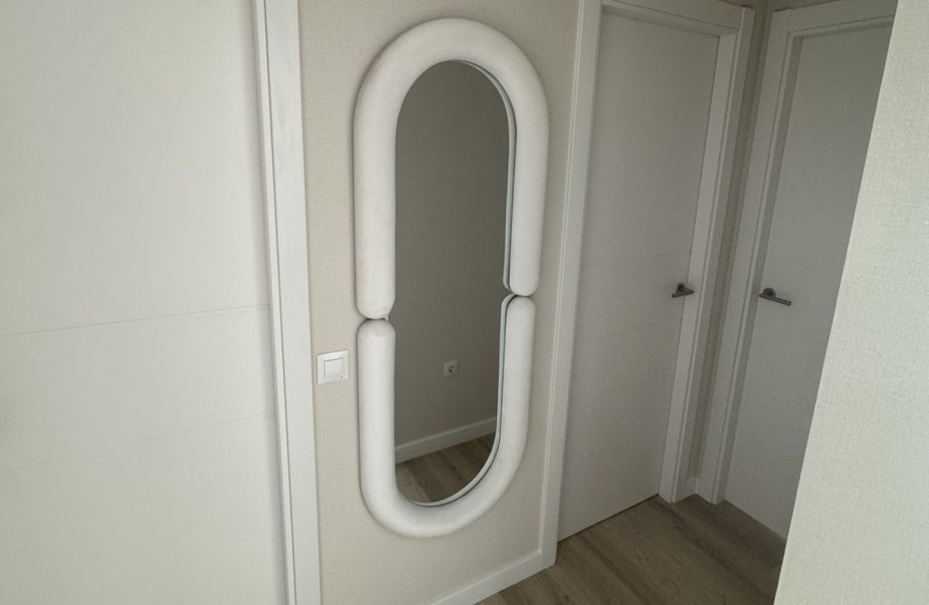 Espejo decorativo de cuerpo entero con marco acolchado en pasillo moderno minimalista